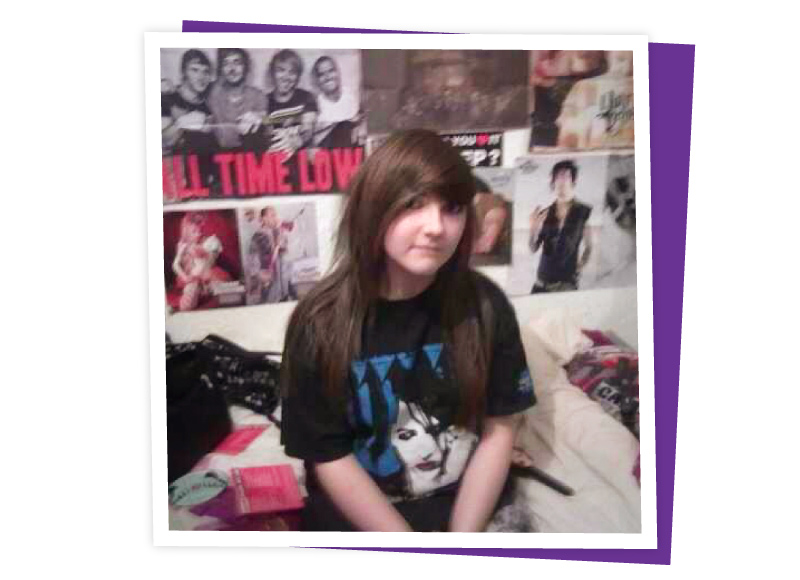 Teenage Jess sat on her bed, surrounded by posters of Emo bands, 2010s. Image donated by Jess Whiting.