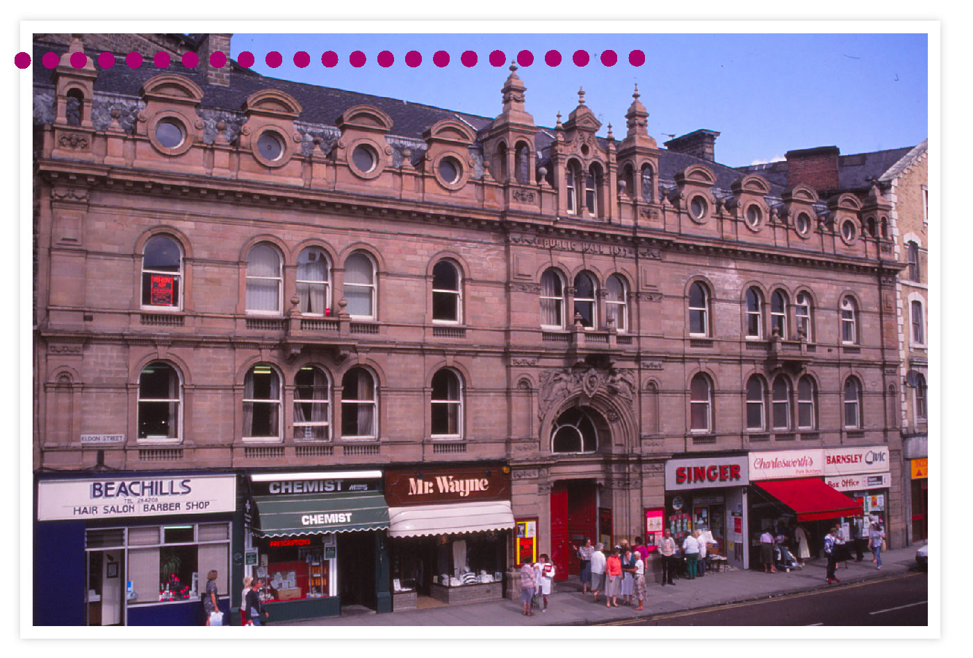 A view of the front of The Civic, with the ground floor shop units, including Mr Wayne, Beachills and Singer, 44 – 56 Eldon Street. Early 1990s © Barnsley Archives.